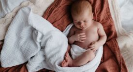 Lifestyle Newborn Photography in a stylish, modern nursery setting